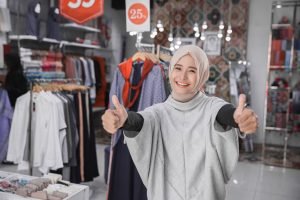 asian female fashion store owner showing thumb up
